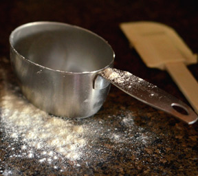 Powdered sugar in measuring cup