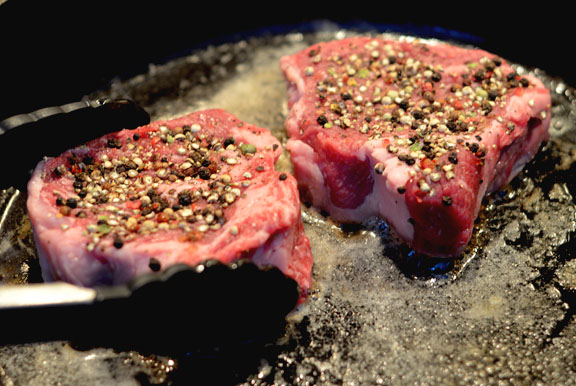 Make strip steaks with pepper in a cast iron skillet.