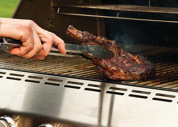 Grilling a steak on the grill