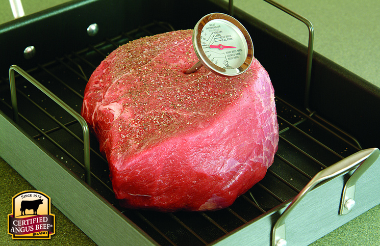 Use an instant-read thermometer to check the doneness of a beef roast.