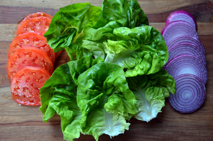 Burger toppings: lettuce, tomato and red onion.