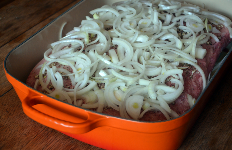 Slice extra-large onion and place onion rings over top of the brisket.