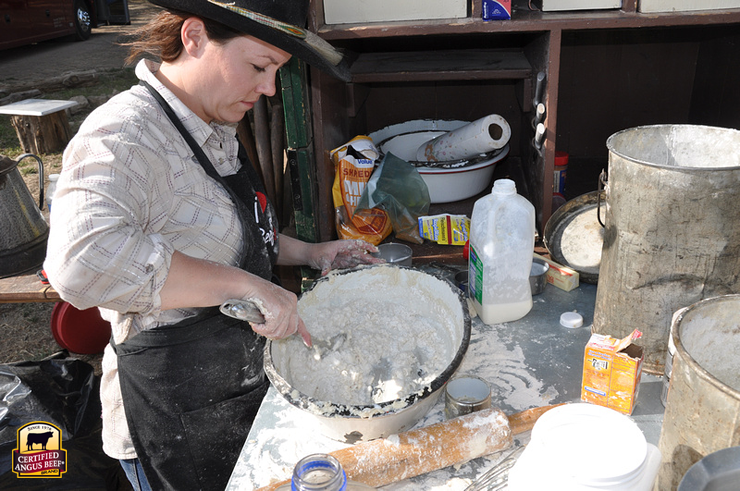 Shannon Rollins prepares angel flake biscuits at a chuck wagon meal.