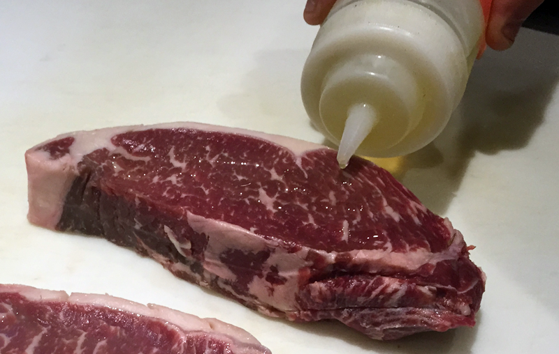 Oil steaks before placing on grill.