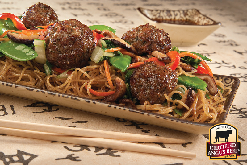 Meatballs and noodles with snow peas.